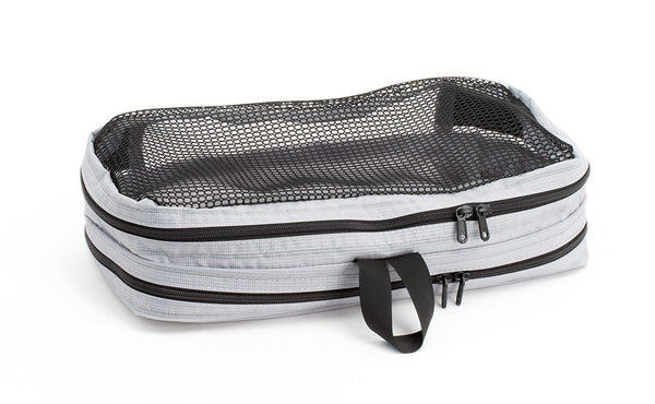 An empty and zipped closed Northwest Sky (light grey) Aether Small Laundry Aeronaut 30 Packing Cube showing the mesh side.